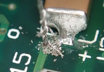 Flaky-Via-Solder-Followed-By-Clean-Curly-Metal.jpg